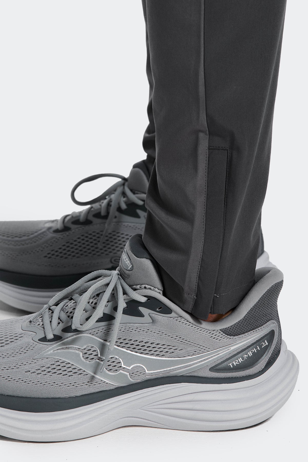 Trail Panel Running Pant - Grey/Orange — Adjustable hem with a zip for a customisable fit.