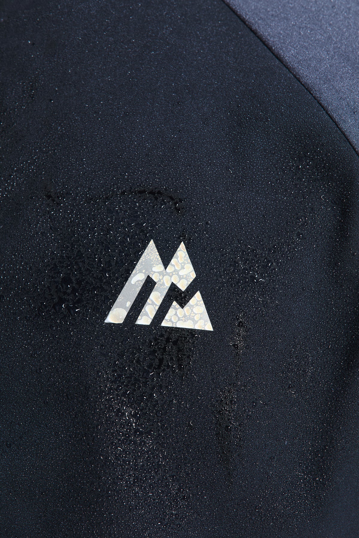 Trion Jacket - Navy Abyss/Graphite/Blue Tide — Reflective detailing on chest and back body.